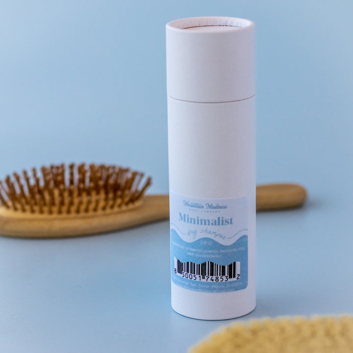 Minimalist Dry Shampoo, a handcrafted dry shampoo. Unscented formula with arrowroot powder, bentonite clay, and cocoa powder.