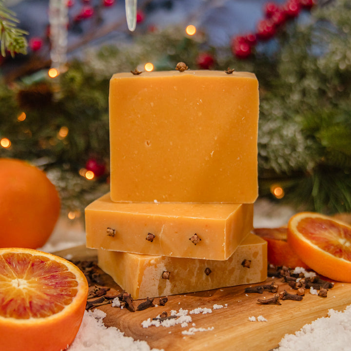 Clementine & Clove Soap, a handcrafted bar soap. Citrus and spicy scent with annatto seeds and whole cloves.