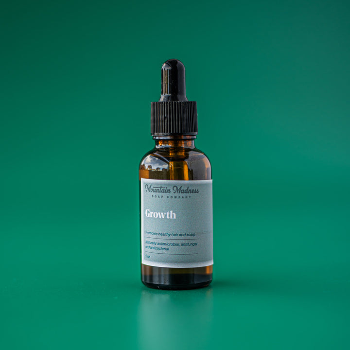 Growth Hair Oil - Citrus herbal handcrafted hair oil with jojoba, argan, and moringa oils in amber glass bottle with dropper