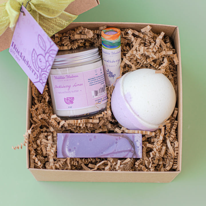 Huckleberry Gift Set, a handcrafted soap collection. Berry and citrus scents in kraft paper packaging.