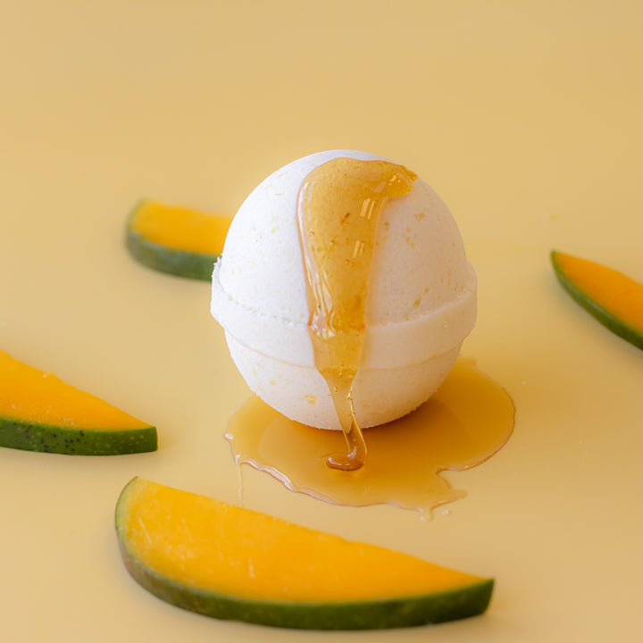 Honey Mango Bath Bomb, a handcrafted bath bomb. Fruity scent with cocoa butter, olive oil, and dried calendula petals.