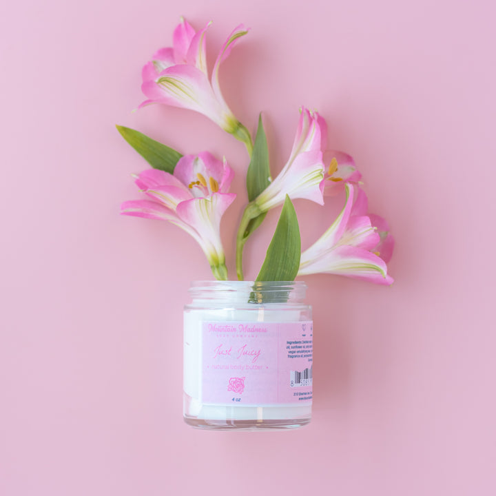 Just Juicy Body Butter, a handcrafted body butter. Floral scent with shea butter, jojoba oil, and cocoa butter.