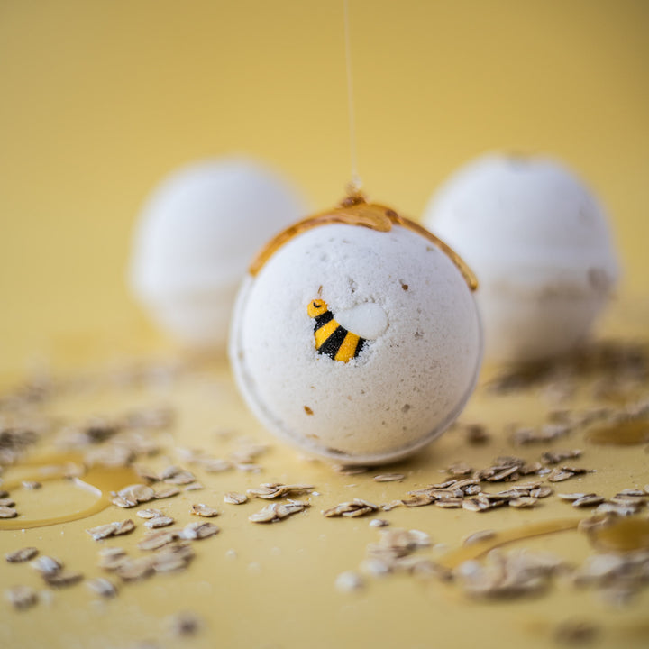 Oats & Honey Bath Bomb, a handcrafted bath bomb. Foodie scent with oatmeal, honey, and cocoa butter.