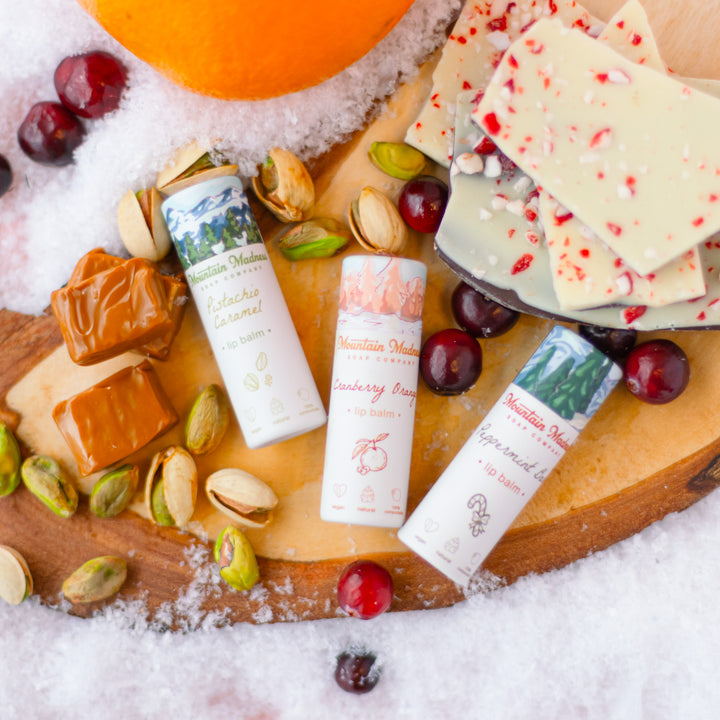 Winter Lip Balm Trio, a handcrafted lip balm set. Berry, citrus, minty, and foodie flavors with coconut oil and vitamin E.